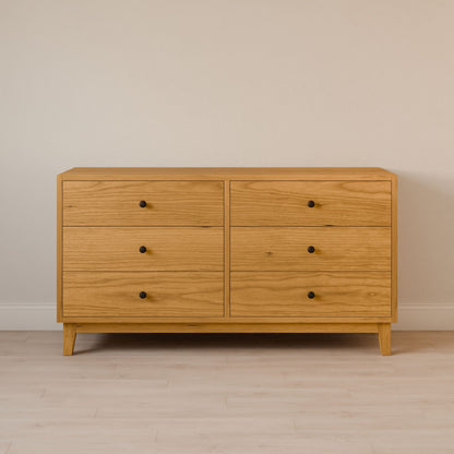 A six-drawer dresser from Krovel Furniture Co., crafted from solid hardwood with a cherry finish and small round black knobs, stands against a plain beige wall on a light wood floor.