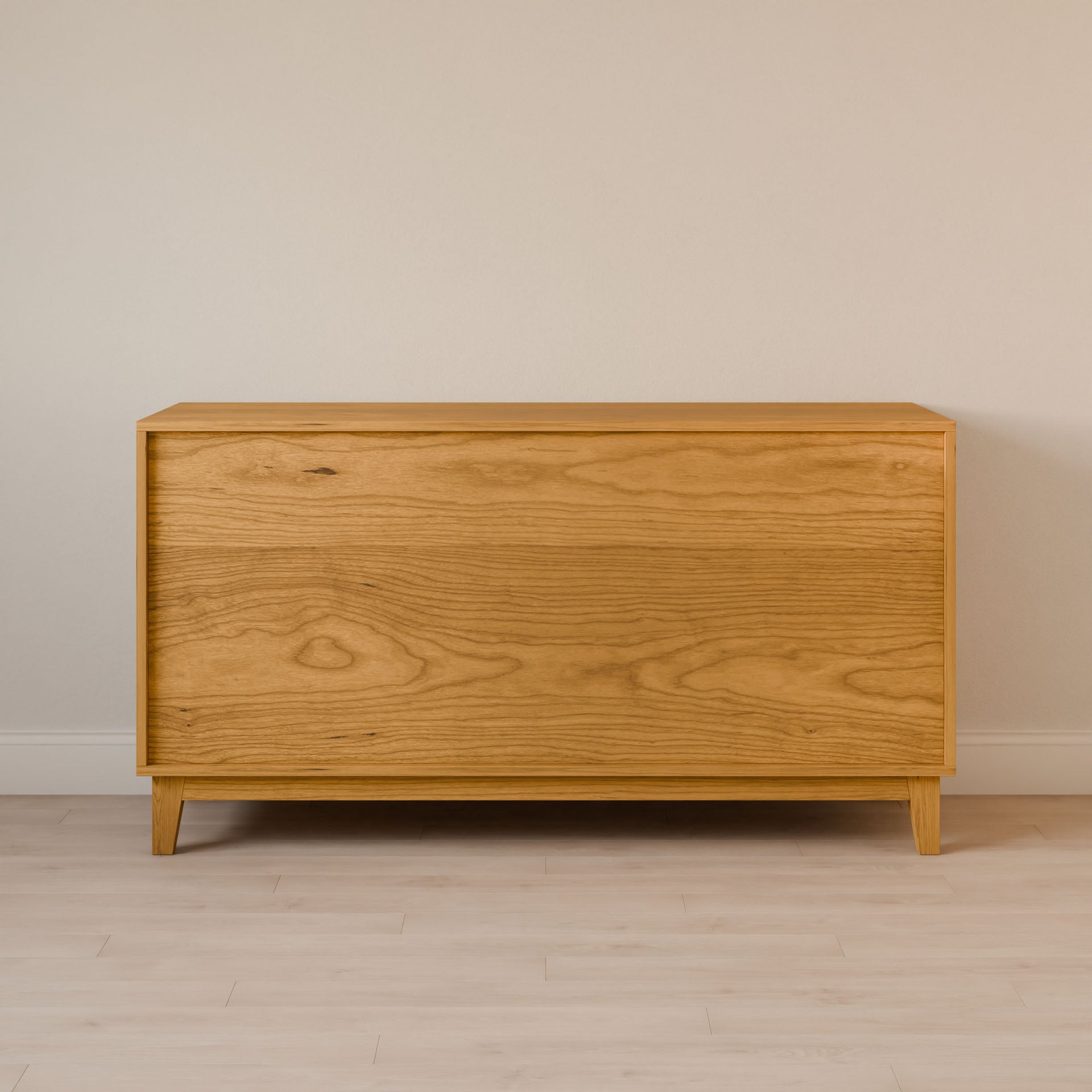 The Krovel Furniture Co. Maine Made Six Drawer Dresser features a minimalist solid wood veneer design with natural grain, clean lines, and no visible handles, set against a beige wall on a light wood floor. Handmade in Portland, Maine.