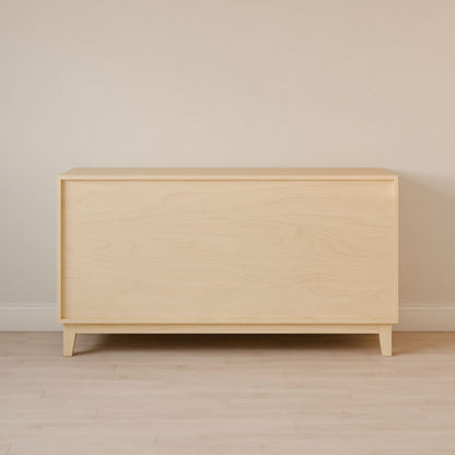 A minimalist Six Drawer Dresser in Maple from Krovel Furniture Co. sits on a light wood floor against a beige wall, featuring a smooth top and simple side panels crafted from sustainable premium plywood for a sleek modern look.