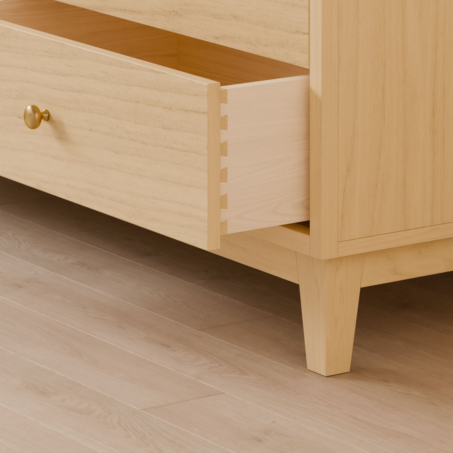 Close-up of the Krovel Furniture Co. Six Drawer Dresser in Maple with an open drawer, crafted from premium plywood. It boasts dovetail joints, a round brass knob, and tapered legs. The matching light wood floor highlights its sustainable construction.