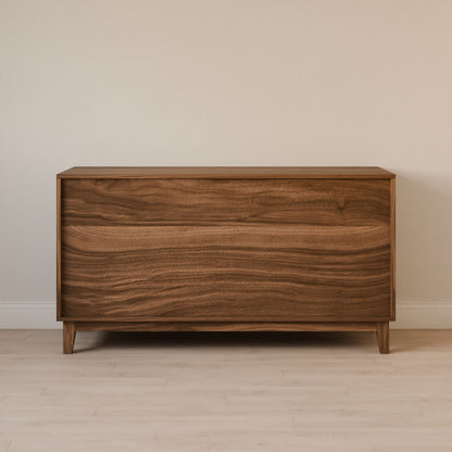 The Six Drawer Dresser in Walnut by Krovel Furniture Co. is crafted from cabinet-grade plywood, featuring a smooth surface with a natural grain pattern. It stands elegantly against a light beige wall on a pale wooden floor, showcasing sustainable construction.