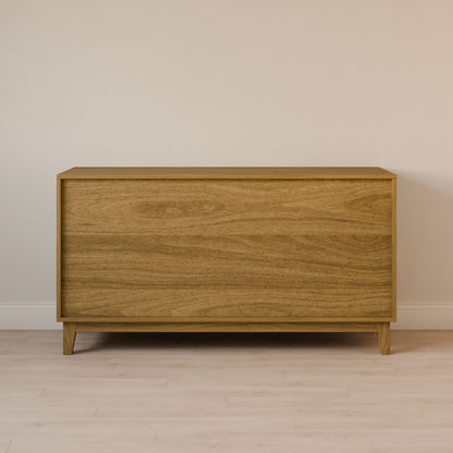 The Six Drawer Dresser in White Oak by Krovel Furniture Co. features minimalist design, sustainable solid hardwood, and natural wood grain. Against a beige wall on a light hardwood floor, it combines simplicity with elegance in any room.