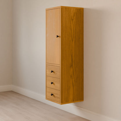 The Triple Drawer Linen Cabinet in Cherry by Krovel Furniture Co. integrates seamlessly into a beige wall, showcasing a minimalist wooden design. It features a tall top door and three drawers below, each with small black knobs, all elegantly positioned above a light wood floor.
