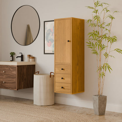 A modern bathroom features a round mirror and eco-friendly design with a wooden vanity. A Krovel Furniture Co. Triple Drawer Linen Cabinet in Cherry hangs on the wall beside a potted bamboo, while a large laundry basket sits below on a patterned rug.