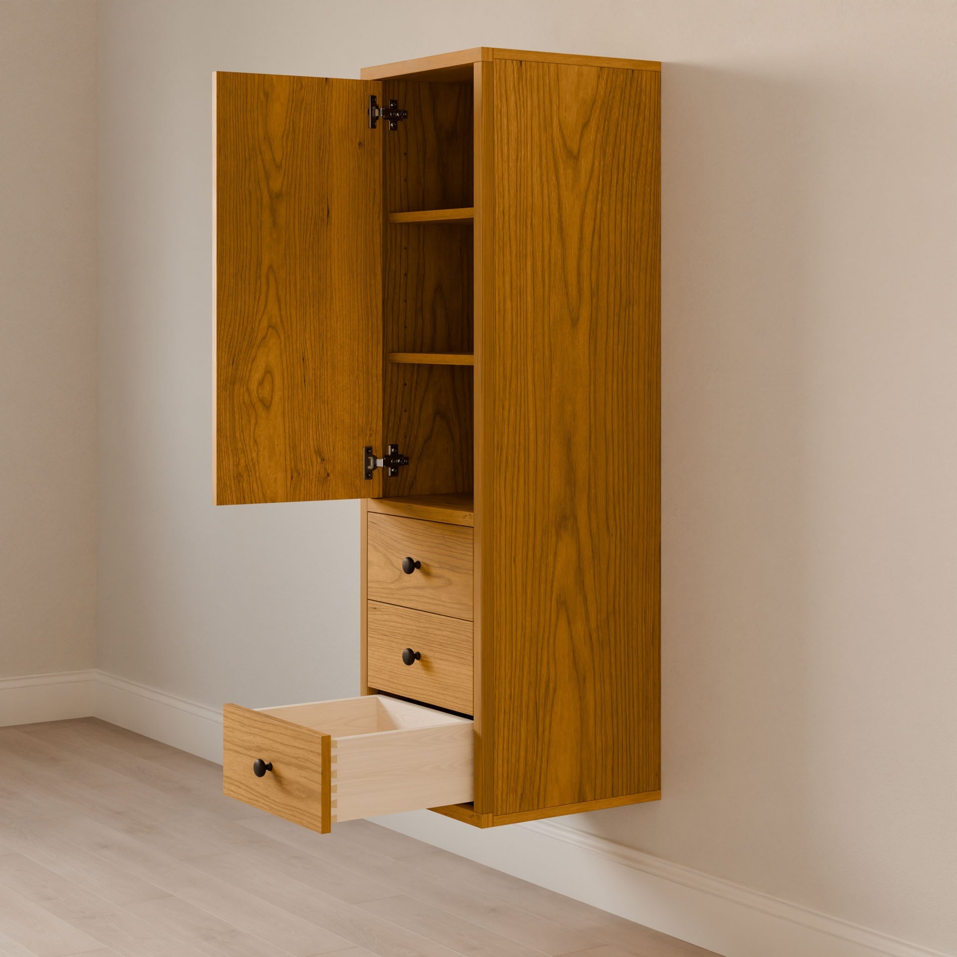 The Triple Drawer Linen Cabinet in Cherry by Krovel Furniture Co. is a wooden wall-mounted bathroom vanity with an open cupboard door revealing shelves and two drawers, one partially open. Crafted sustainably, its natural cherry finish complements the light-colored floor and wall beautifully.