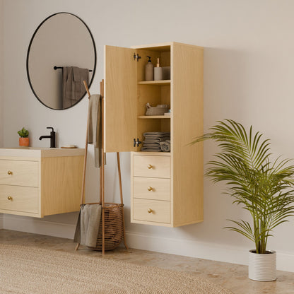 A minimalist bathroom showcases the Triple Drawer Linen Cabinet in Maple by Krovel Furniture Co. It features light wooden cabinets. Above the sink, a round mirror and black faucet are visible. A plant is beside the linen cabinet, while soft-close drawers house neatly stacked towels and toiletries.