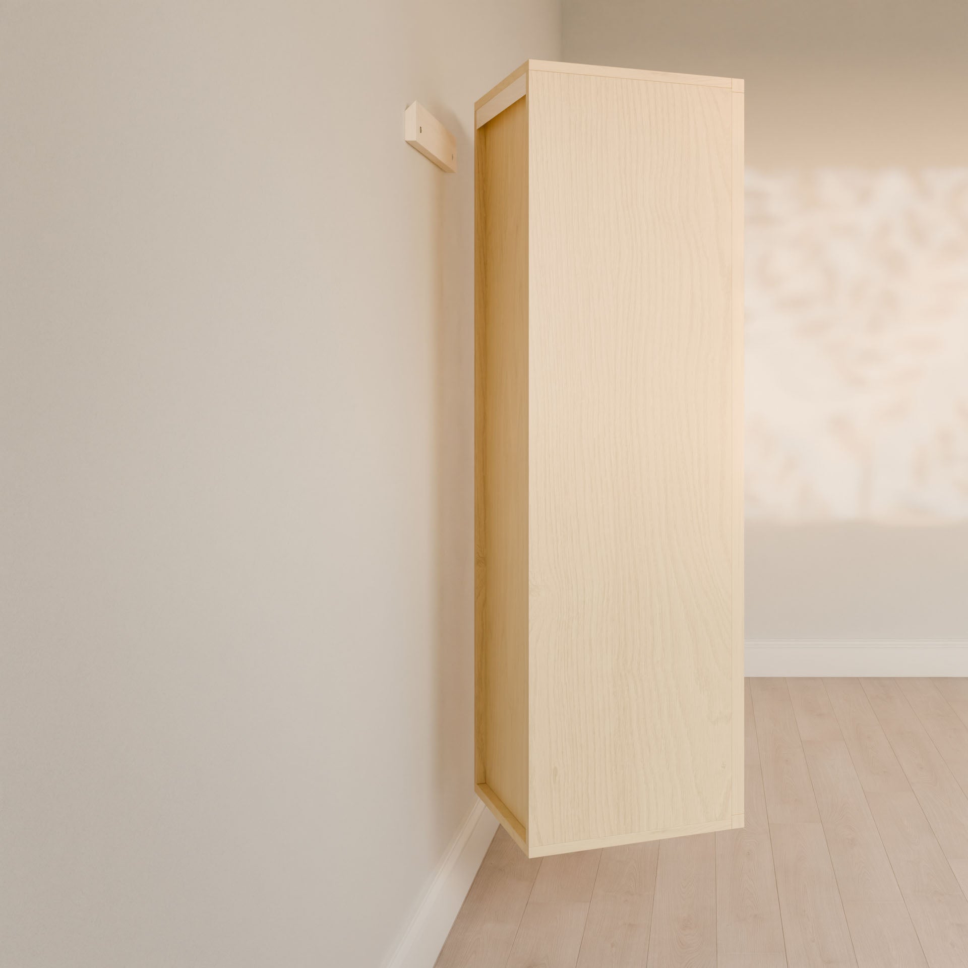 The Triple Drawer Linen Cabinet in Maple by Krovel Furniture Co. appears to float against a pale wall, casting shadows of leaves. Its open design with elegant hardwood face frames is complemented by light wood flooring, adding warmth to the minimalist setting.