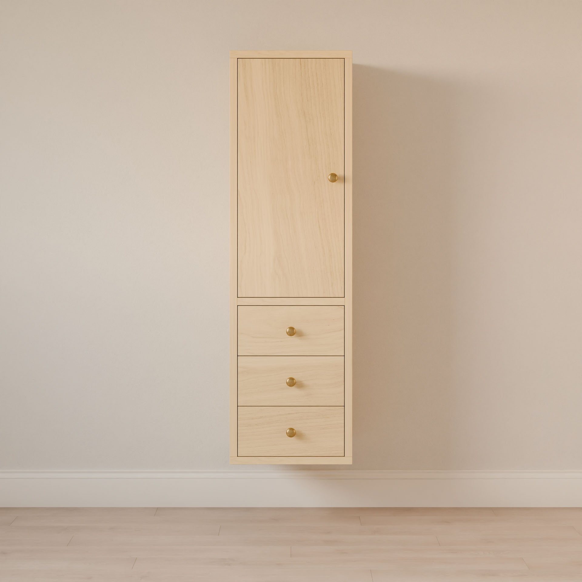 The tall Triple Drawer Linen Cabinet in Maple from Krovel Furniture Co. features a hardwood face frame, a top door, and three soft-close drawers with small round golden knobs. Its set against a neutral beige wall above a light wooden floor.