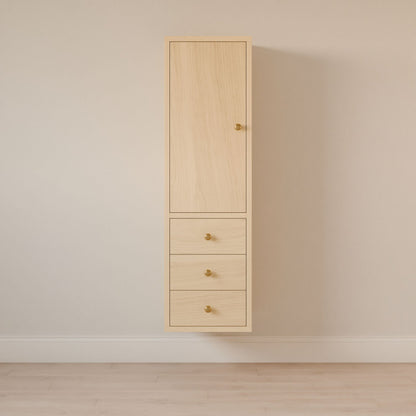 The tall Triple Drawer Linen Cabinet in Maple from Krovel Furniture Co. features a hardwood face frame, a top door, and three soft-close drawers with small round golden knobs. Its set against a neutral beige wall above a light wooden floor.