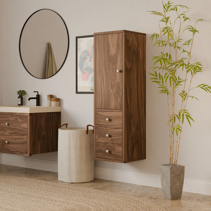 A modern bathroom showcases floating wooden cabinets and a round mirror, completed with sustainable construction. A circular laundry basket sits by the sink beneath abstract art. Adding to the minimalist design, neutral hues complement Krovel Furniture Co.s elegant Triple Drawer Linen Cabinet in Walnut.