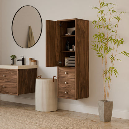 A modern bathroom features a round mirror over a floating wooden vanity. The Krovel Furniture Co.s Triple Drawer Linen Cabinet in Walnut showcases toiletries and towels, while a beige laundry basket and potted bamboo plant on light flooring demonstrate sustainable construction principles.