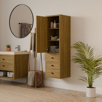 A modern bathroom features a round mirror, floating solid hardwood vanity, Krovel Furniture Co. Maine Made Triple Drawer Linen Cabinet with open doors displaying shelves and drawers, a towel rack, wicker basket, and potted plant on a light floor.