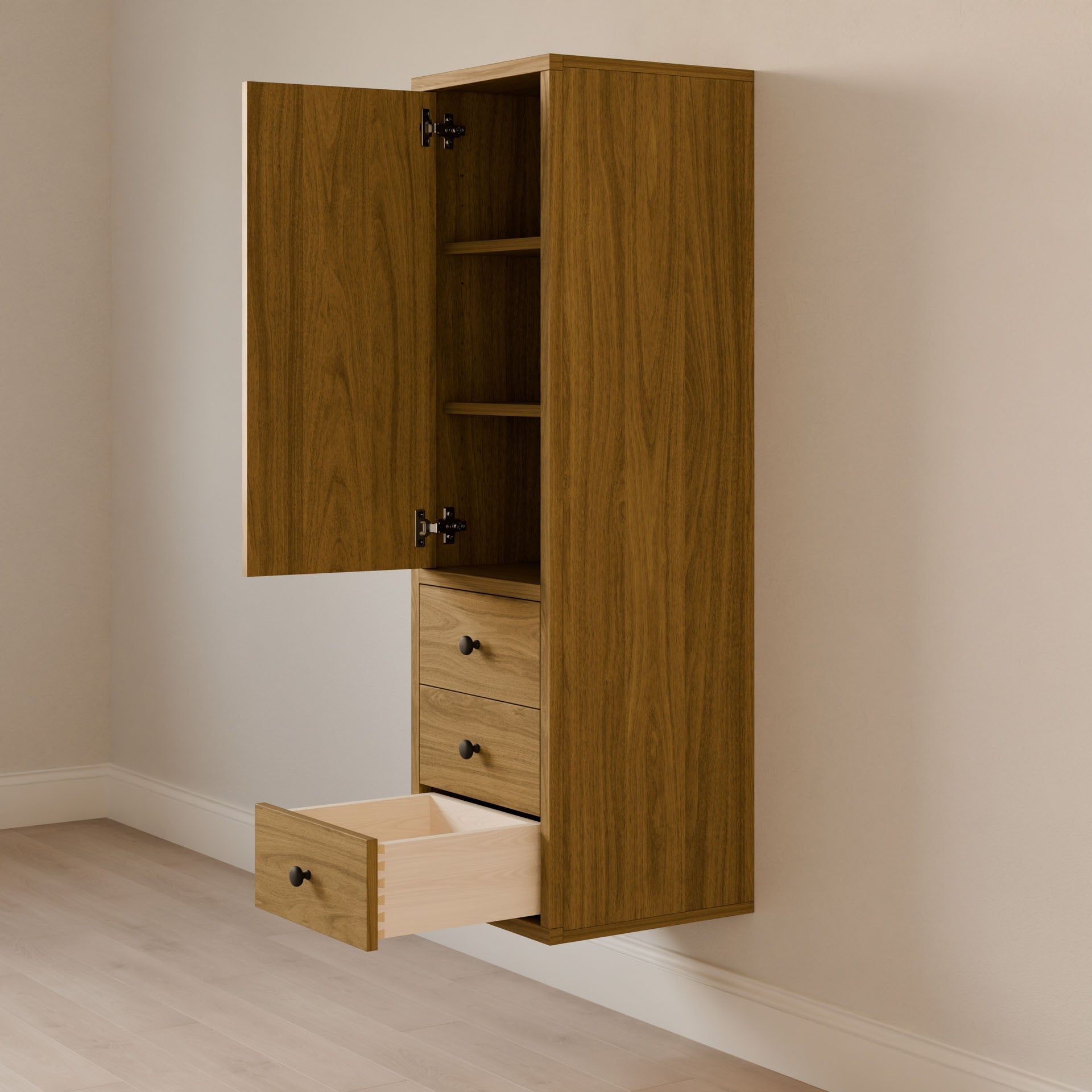 A Krovel Furniture Co. Triple Drawer Linen Cabinet in White Oak is mounted on a beige wall, with its door open to reveal shelves inside and one drawer partially pulled out. The light wood floor complements the cabinets natural finish, highlighting sustainable construction practices.